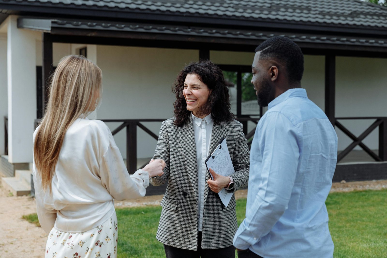 Couple reviewing documents at a table, symbolizing successful home sale without a realtor