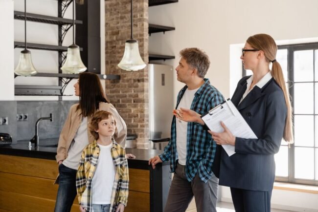 A family converses with a real estate agent about a modern home interior